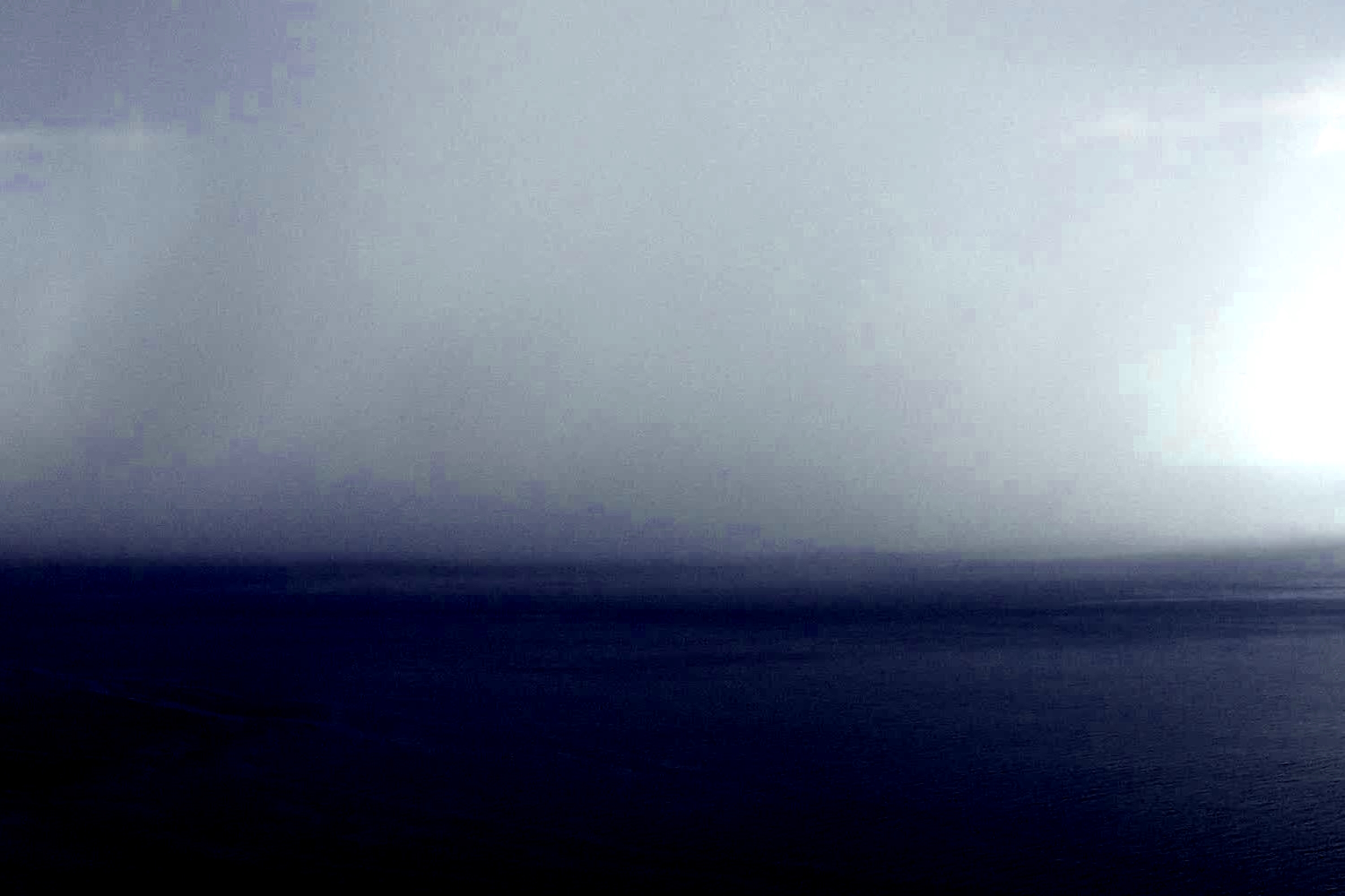 dark clouds over foggy sea